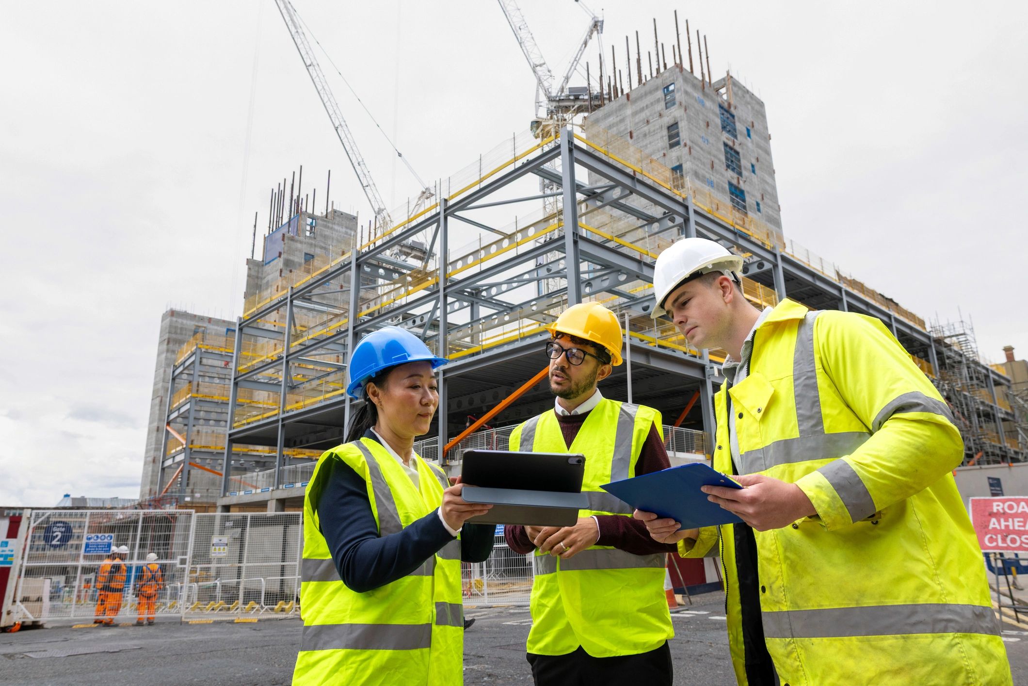 Construction professionals reviewing plans on site